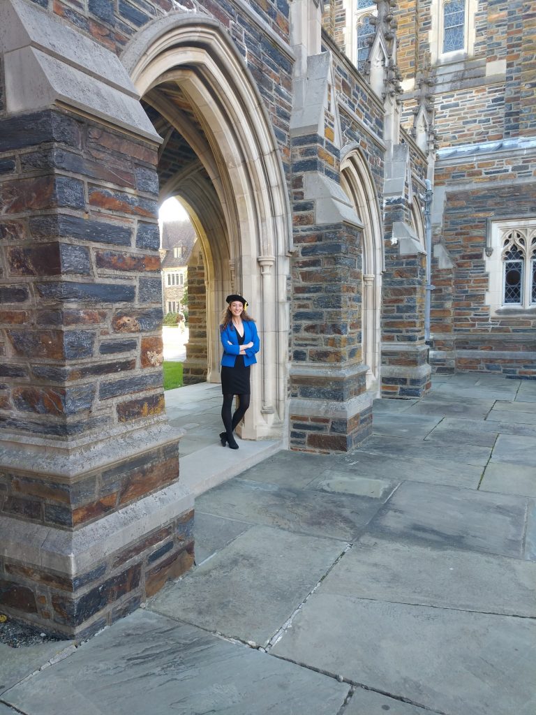 Kirsten Overdahl wearing her PhD tam and her dissertation defense near Duke Chapel