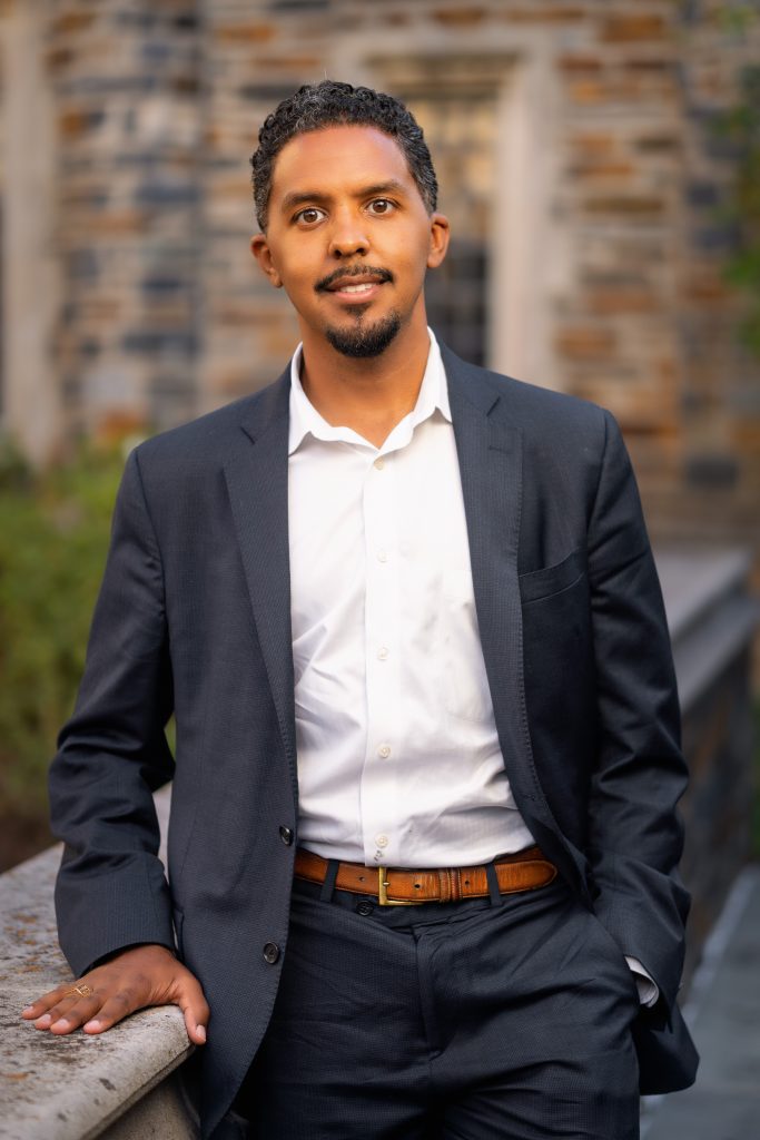 Seminar speaker, Dr. Andrew Jones III, standing outside of a brick building on the Duke University campus