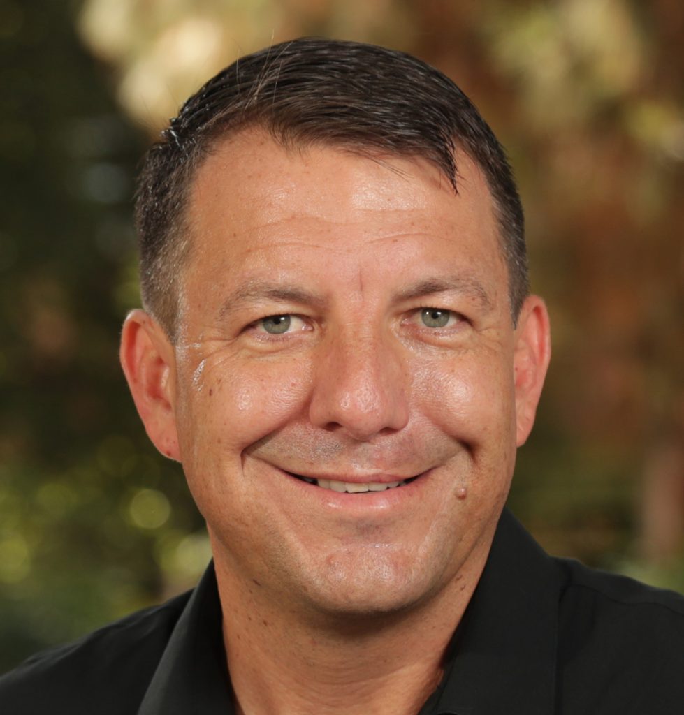 Headshot of seminar speaker, David Volz, PhD, in front of a blurred background