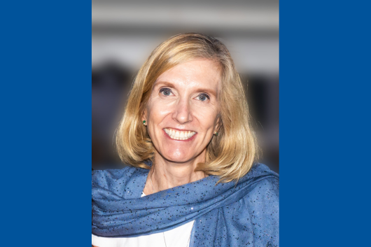 Seminar speaker, Kari Nadeau, smiling and wearing a blue scarf.